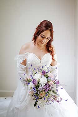 Bride smiling outdoors wearing timeless natural wedding makeup